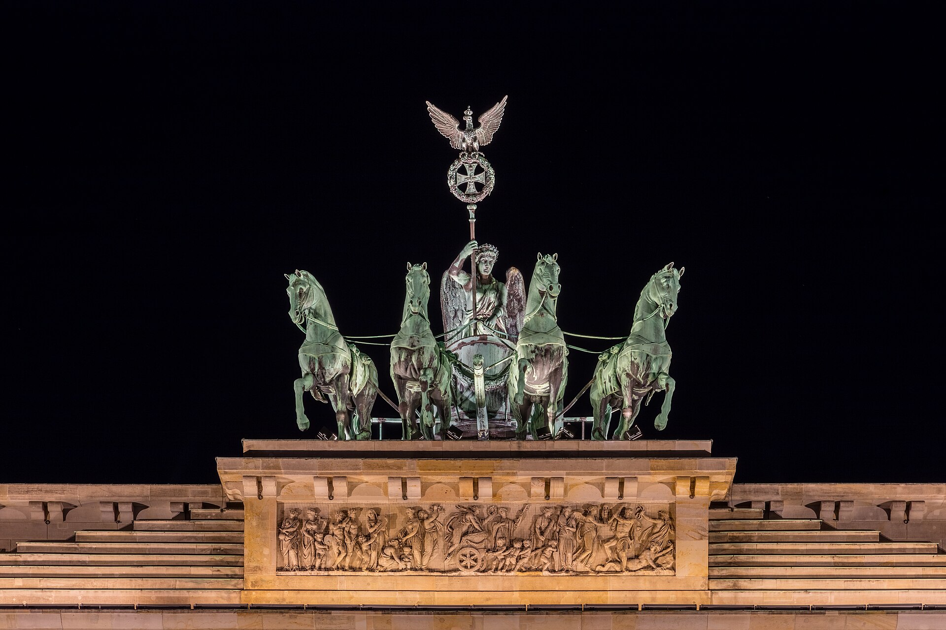 Cuadriga de la Puerta de Brandenburg, Berlín, Alemania. La construcción de la puerta, que se realizó entre entre 1788 y 1791, fue orden del rey Federico Guillermo II de Prusia como símbolo de paz. Fue considerablemente dañada durante la Segunda Guerra Mundial y durante la división de Alemania tras la posguerra se hizo inaccesible al situarse el Muro de Berlín directamente frente a ella. Las cercanías de la puerta tuvieron una cobertura mediática importante durante la caída del muro en 1989 y la 